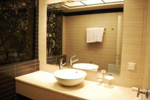 a bathroom with a sink and a mirror at Sun George in Finikounta
