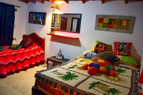 Un dormitorio con dos camas y una cama con un animal de peluche. en Casa de Campo en San Pedro, en San Pedro