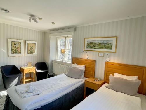 Postel nebo postele na pokoji v ubytování Mauritzbergs Slott & Golf