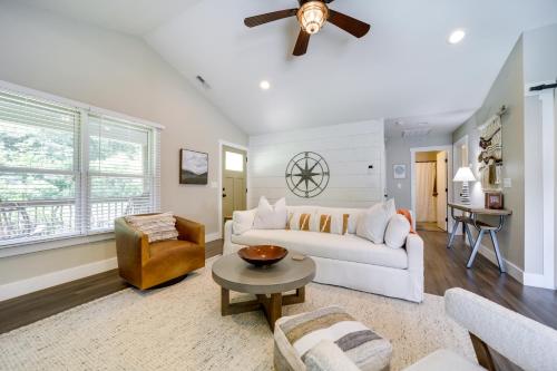 a living room with a white couch and a ceiling fan at Deck and Mtn Views Riverfront Cullowhee Home in Cullowhee