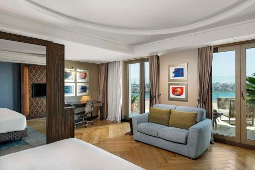 a bedroom with a bed and a couch and a desk at Radisson Blu Hotel Istanbul Pera in Istanbul
