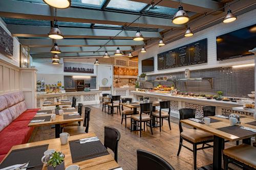 a restaurant with wooden tables and chairs and a bar at Radisson Blu Hotel Istanbul Pera in Istanbul