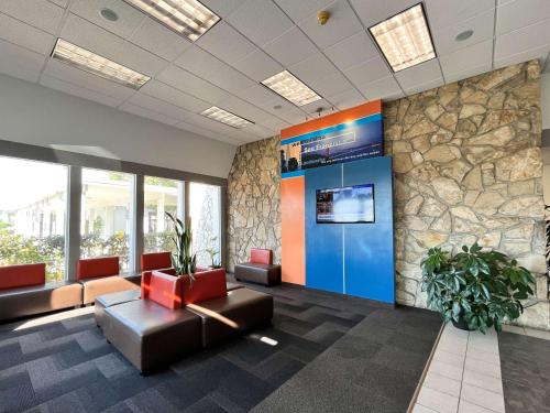 an office lobby with a large wall of windows at Studio 6 Belmont, CA San Francisco Redwood in Belmont