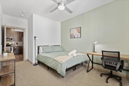 a bedroom with a bed and a desk and a chair at Luxe 3B/2B Getaway - Pool, Gym, Parking, Pet Wash in Leander
