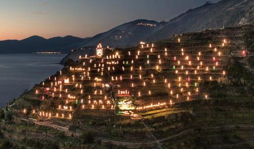 a bunch of buildings on a hill at night at CasarinoLaurino Among Cinque Terre Genova And Portofino in Uscio