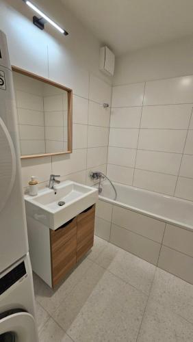 a bathroom with a sink and a bath tub at 2 room Apartment with terrace, 2AK in Bratislava