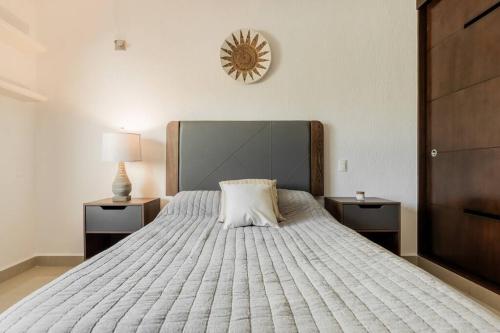 a bedroom with a large white bed with two night stands at Stylish Lagoon front Villa by Casa Paraiso in Cancún