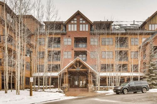 a car parked in front of a large brick building at The Springs Condominiums by Vail Resorts in Keystone