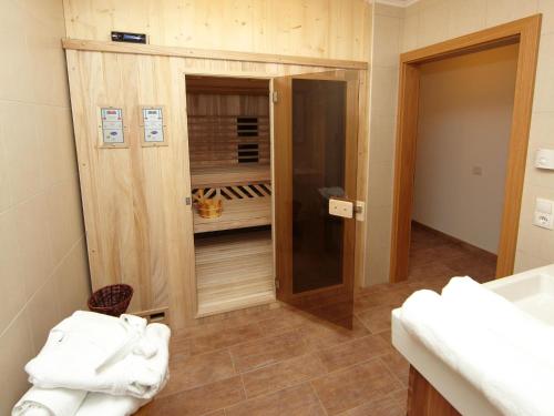 a bathroom with a sink and a closet with towels at Chalet Vorderjausern in Saalbach-Hinterglemm