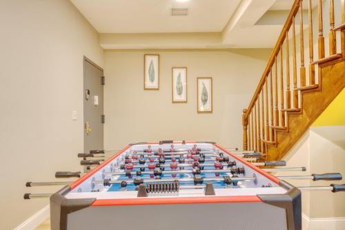 a large foosball table in a room with stairs at The Cherry Suites - Chinatown in Philadelphia