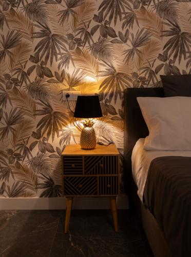 a lamp on a night stand next to a bed at Apartamento Suite 48- Recién reformado in Avilés