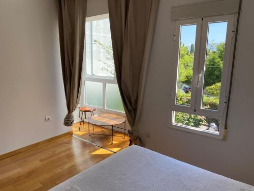 a bedroom with a bed and a large window at Casa de la abuela Elisa - Ribeira Sacra - Cañones del Sil - Caurel in Quiroga