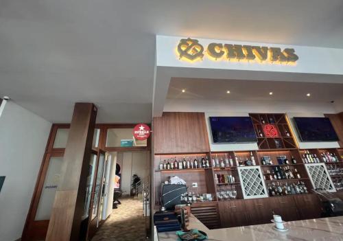 a restaurant with a bar with a sign on the wall at Departamento en Manta Edificio Poseidon in Manta