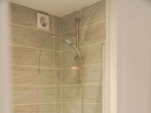 a bathroom with a shower with a glass door at Home in Speke- 8 mins walk to airport in Speke