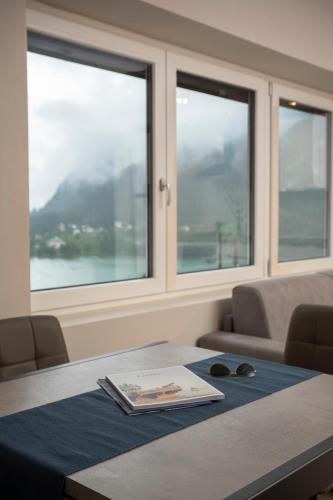 a conference room with a table and two windows at SnowLake Suite & Apartment in Alleghe