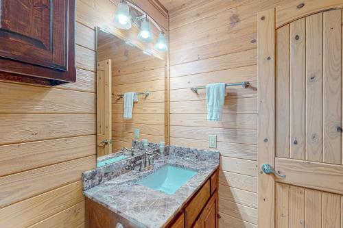 a bathroom with a sink and a mirror at Executive Cabin in Bentonville