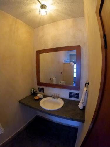 a bathroom with a sink and a mirror at relax hotelito in Cárdenas