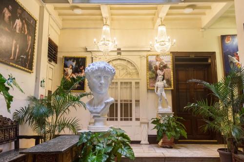 a statue in the middle of a room with plants at Casa Lima in Lima