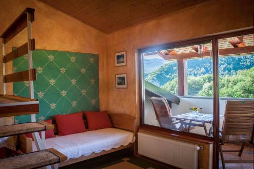 a room with a window and a table and chairs at Tourist Farm Kranjc in Kobarid
