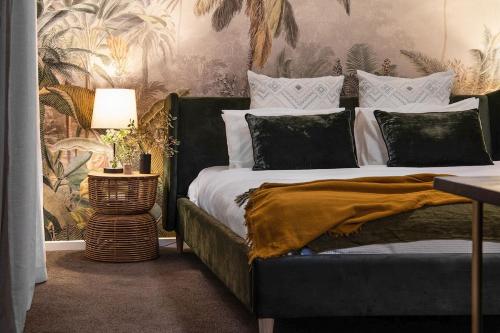 a bedroom with a bed and a table with a lamp at Kuca Stone in Daylesford