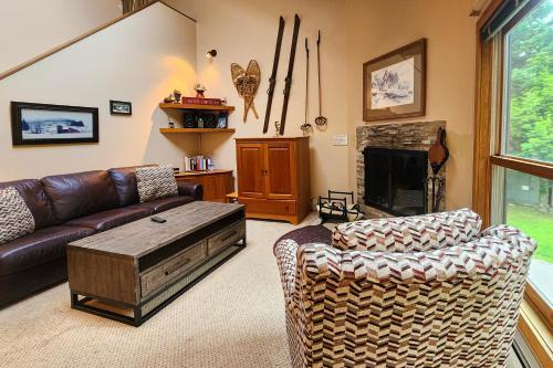 a living room with a couch and a fireplace at Trail Creek 62 in Killington