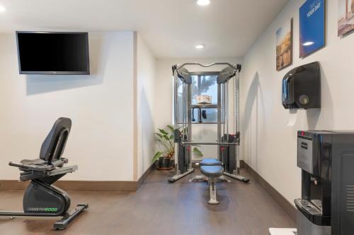 a room with a gym with weights and a tv at Comfort Inn & Suites Redwood Country in Fortuna