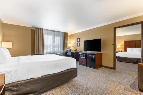 a hotel room with a large bed and a flat screen tv at Comfort Inn & Suites Redwood Country in Fortuna