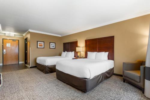 a hotel room with two beds and a couch at Comfort Inn & Suites Redwood Country in Fortuna