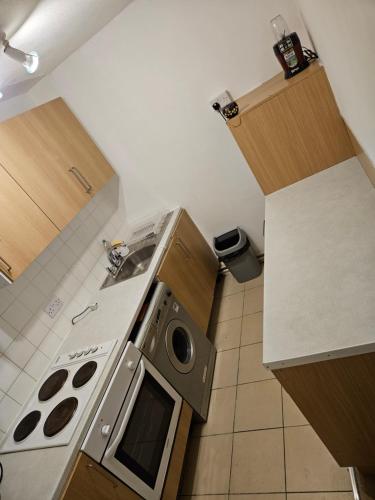 a small kitchen with a stove and a sink at Flat in Camden Town in London