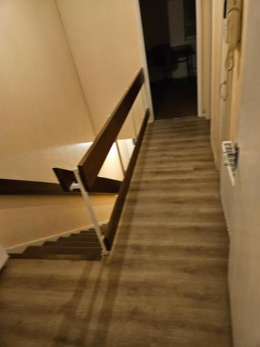 a stairway in a building with a wooden railing at Flat in Camden Town in London