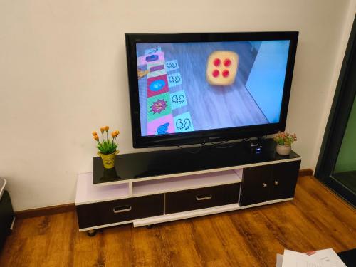 a flat screen tv sitting on top of a entertainment center at Littleching vivacity jazz 3 @2bedroom in Kuching