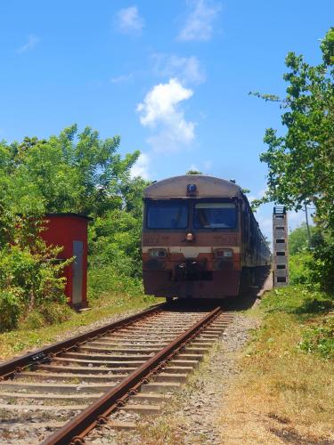 a train is traveling down the tracks at River Front Villa in Wadduwa