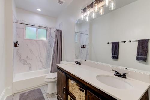 a bathroom with a sink and a toilet and a shower at The Wilsonia in Memphis