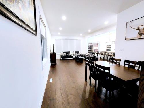 a dining room with a table and chairs and a living room at Luxurious and Spacious Home in Denfield