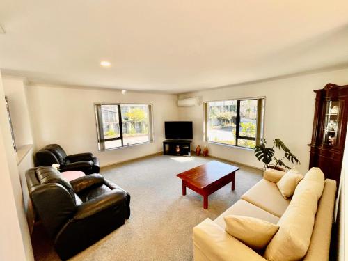 a living room with two couches and a coffee table at Abeam of Reserve Living in Rotorua