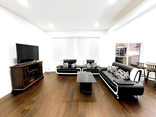 a living room with a couch and a tv at Luxurious and Spacious Home in Denfield