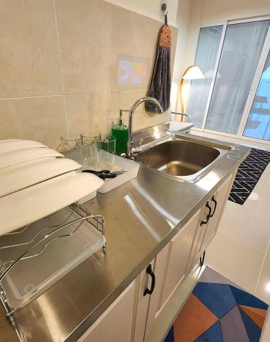 a kitchen with a sink and a stainless steel counter at THE SHORE KOTA KINABALU - SABAKUBA HOMESTAY B13-13A in Kota Kinabalu