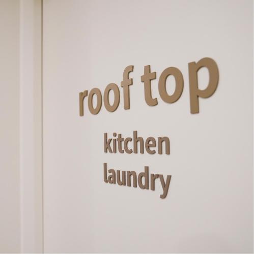 a sign that reads roof top kitchen laundry at SimpleStay Hotel in Jongno in Seoul