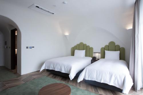 Ein Bett oder Betten in einem Zimmer der Unterkunft Ecoland Hotel