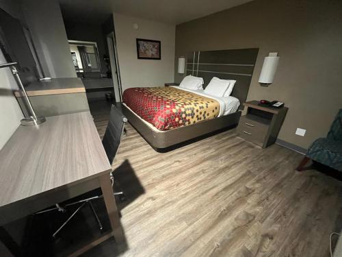 a hotel room with a bed and a desk at Econo Lodge Inn & Suites Murfreesboro Shopping District in Murfreesboro