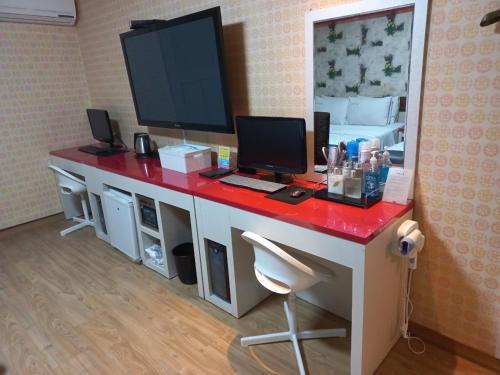 a room with a desk with a computer on it at Sky Hotel in Hwaseong