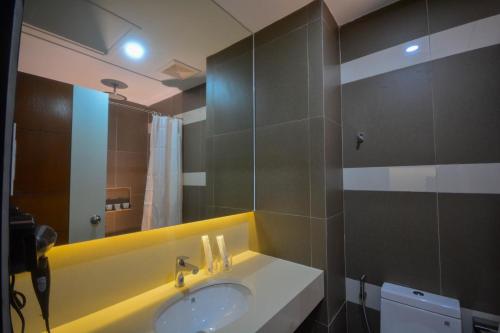 a bathroom with a sink and a mirror at Sotogrande Hotel Palawan in Puerto Princesa City