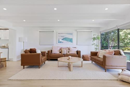 a living room with two couches and a table at Bayview House with SAUNA and SPA by Ready Set Stay in Cowes
