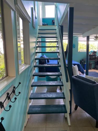 a spiral staircase in a room with windows at Manta Soul Suites in Kealakekua