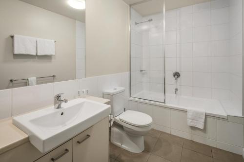 a bathroom with a toilet and a sink and a shower at Quest Mildura in Mildura
