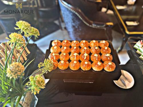 a bunch of donuts sitting on a table at Monarque Hotel Danang in Da Nang