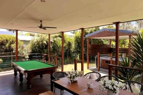 a patio with a pool table and chairs at Bayview House with SAUNA and SPA by Ready Set Stay in Cowes