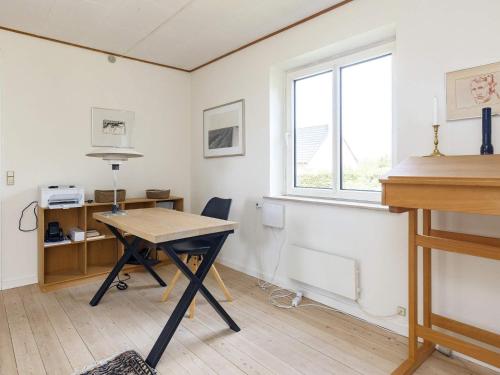 an office with a desk and a table and a window at Seaside Charm in Gedser - By Traum Ferienwohnungen in Gedser