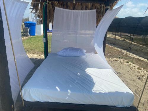 a bed in a tent on the beach at Cabaña La Guadalupana, paga 2 noches y te obsequio la 3ra in Los Córdobas