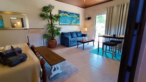 a living room with a blue couch and a table at Suite Dream Blue in Tamarindo